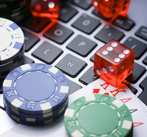 Chips, cards and dice on a computer.